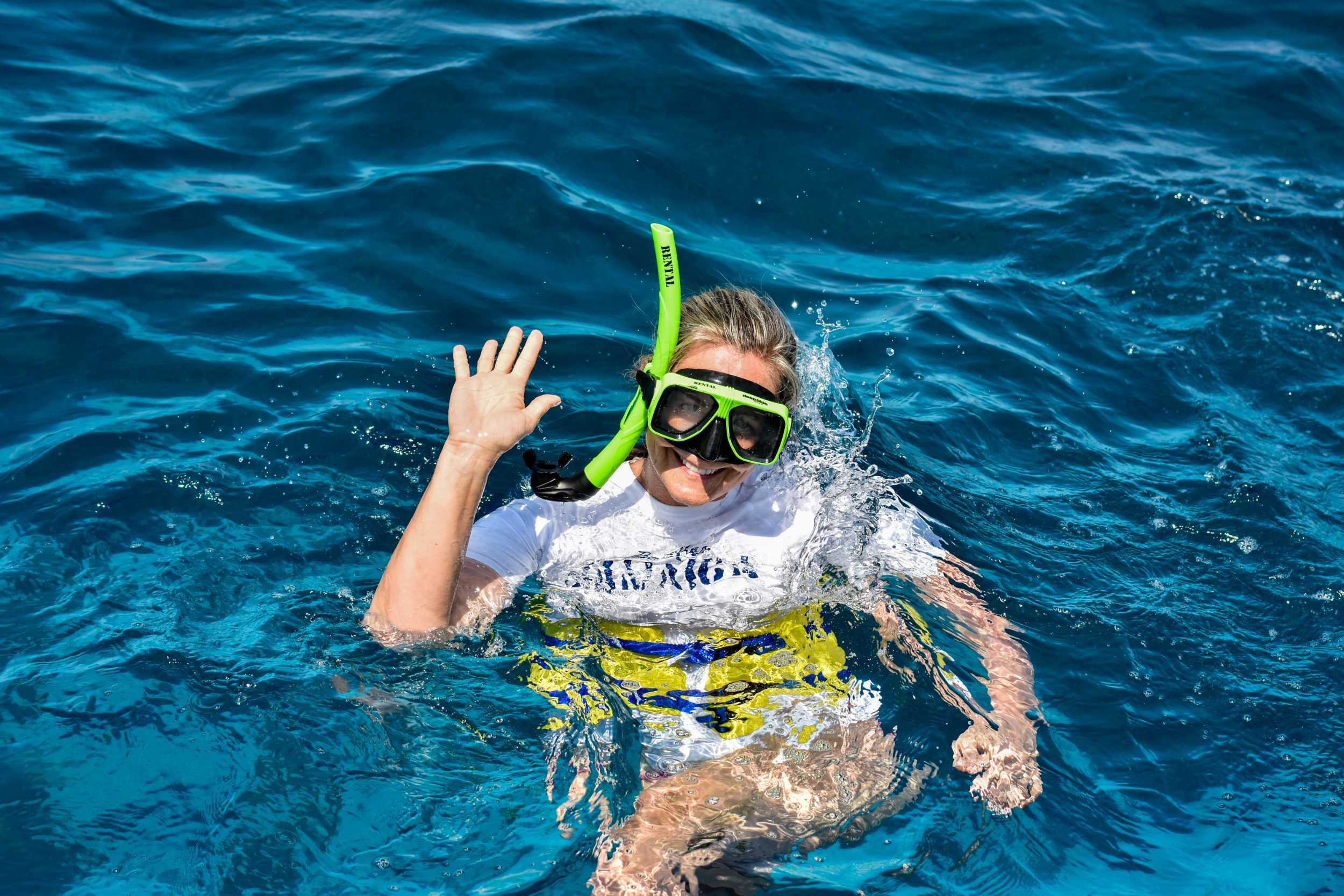 Young swimmer wearing a mask and snorkel in open water