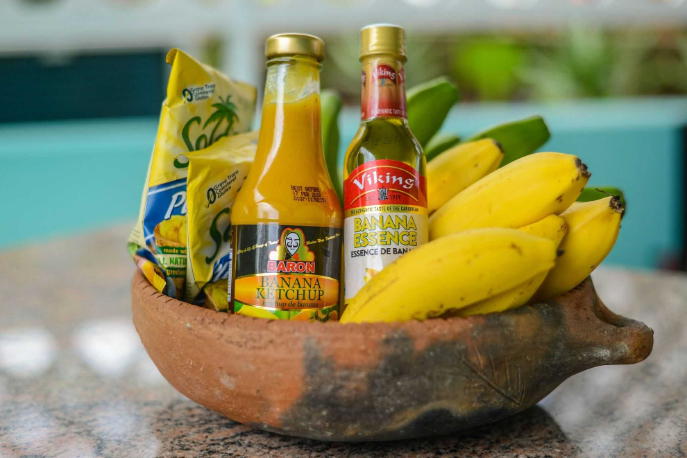 Bananas and locally made fruit products arranged in a wooden bowl
