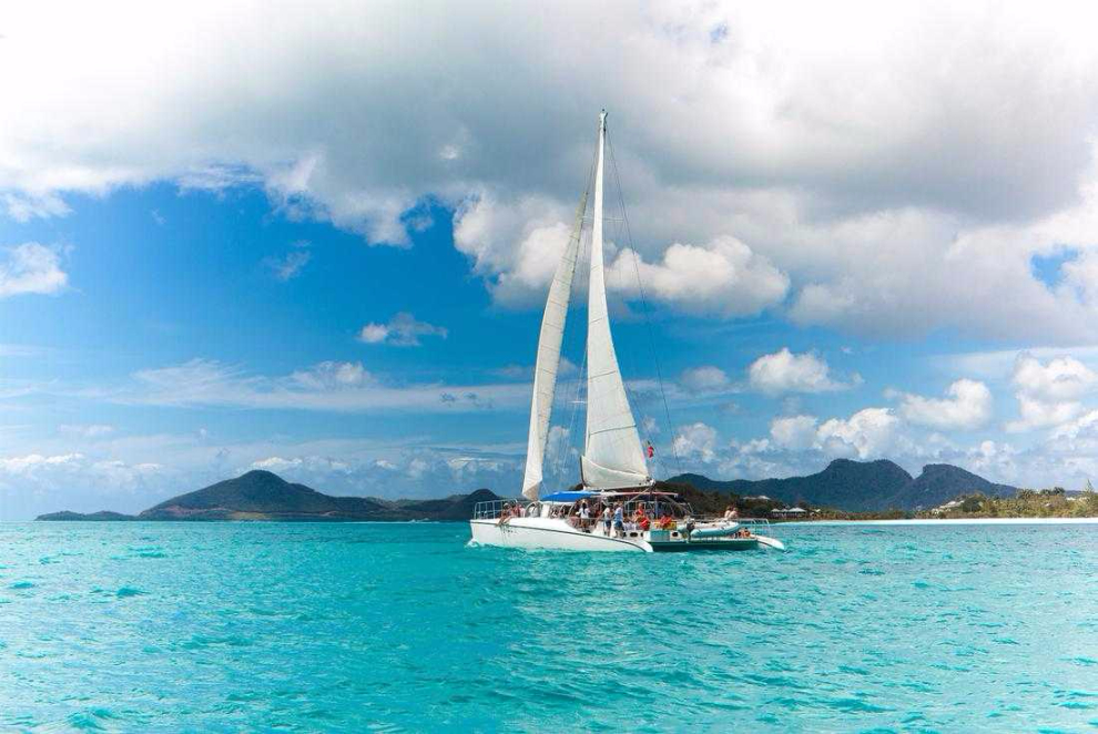 Catamaran sailing through clear water near Antigua