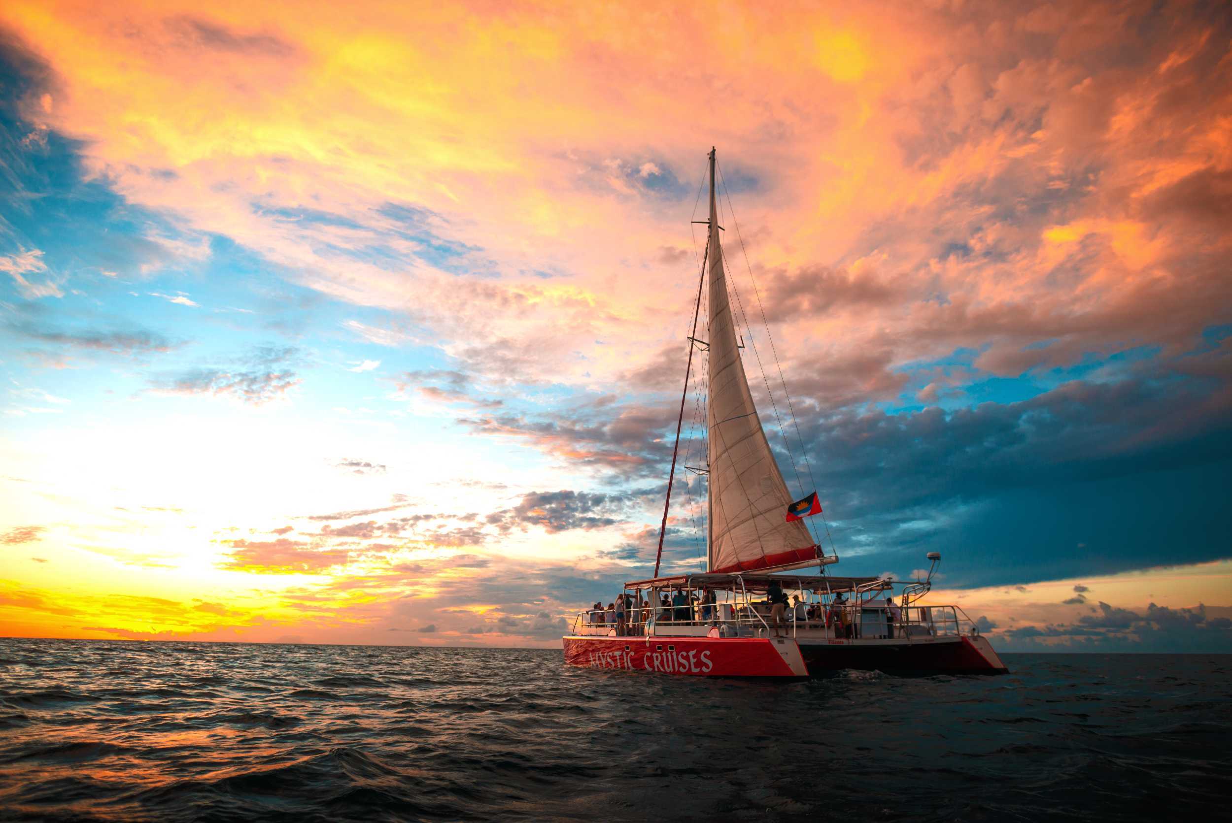 Private catamaran sailing off Antigua at sunset