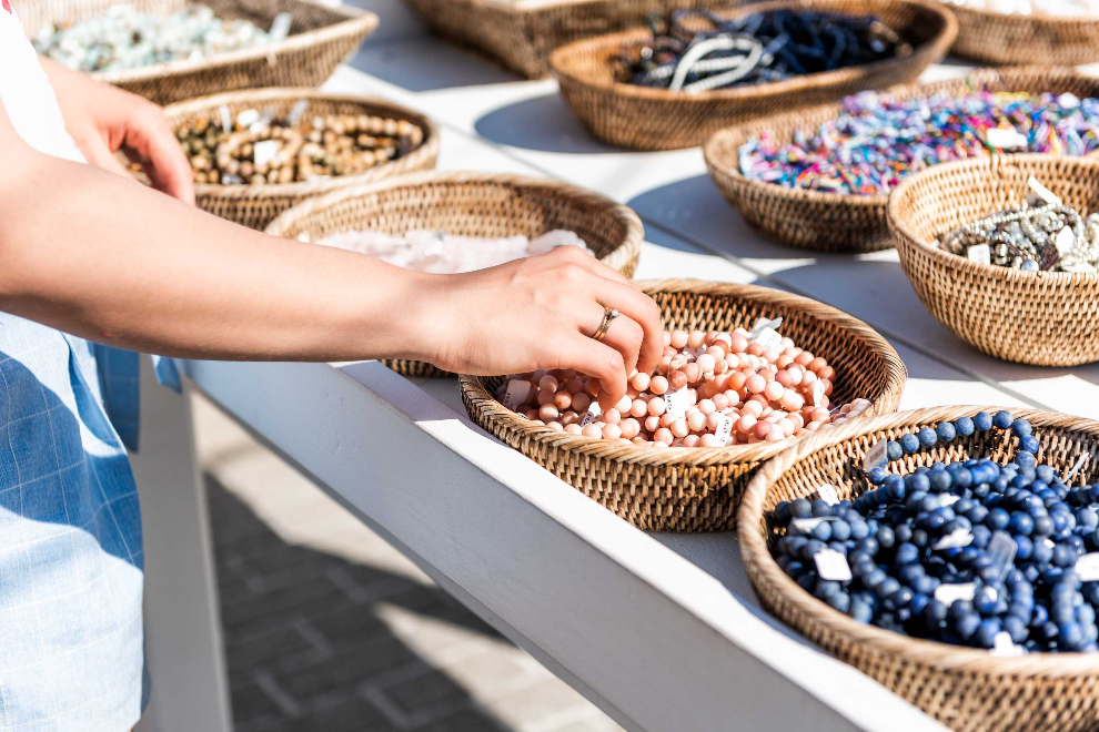 Shopper choosing beads displayed in woven baskets