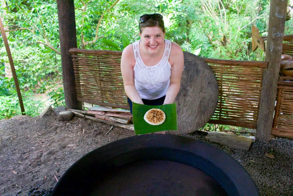 Visitor holding a tray of grain during a local food demonstration
