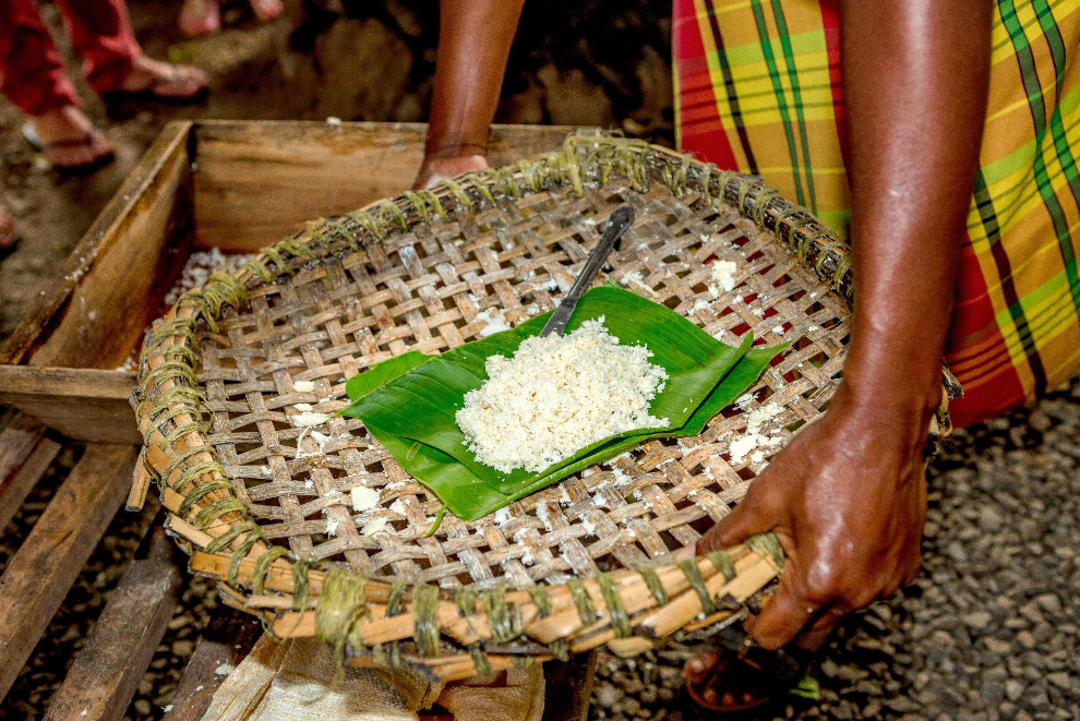 Food ingredients displayed on a leaf in a handwoven tray