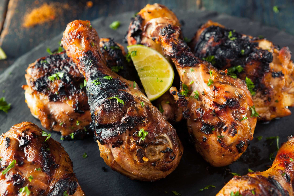 Grilled jerk chicken served with lime and herbs